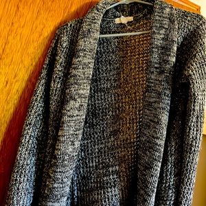 Woman’s black and white long, chunky cardigan